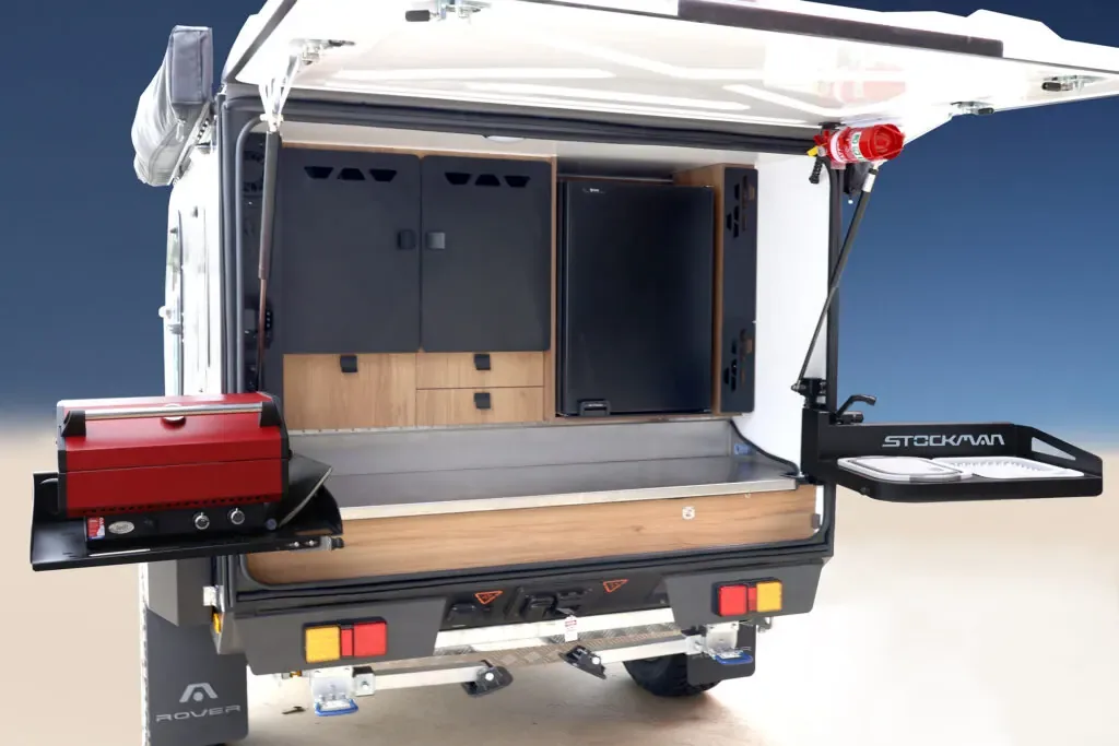 Rover rear open showing the outdoor kitchen and fridge