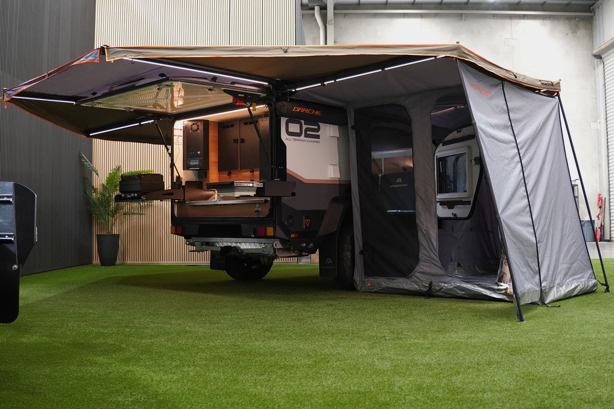 The Rover 02 driver-side change room set up beside the camper with the Darche 180 awning extended