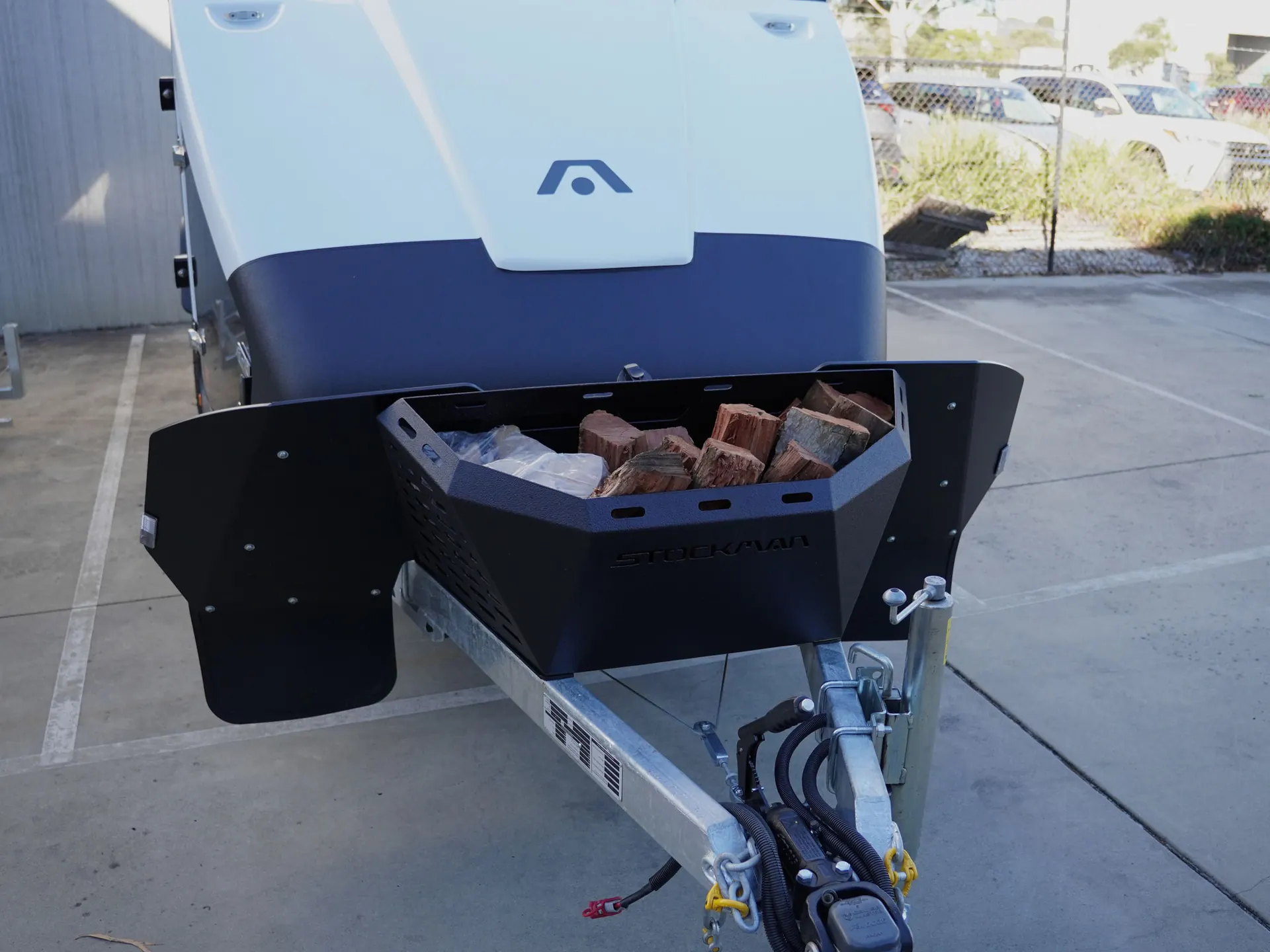Front-mounted Stockman external wood box filled with firewood on a Rover 02 drawbar