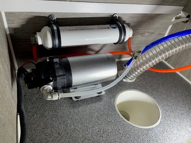 Inline water filter and pump fitted under the Rover 02 bench