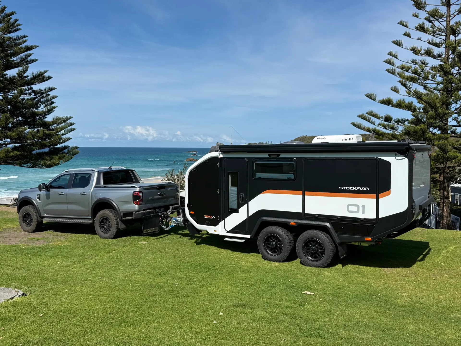 Stockman Trekka 01 hitched to a ute on a coastal headland above the beach