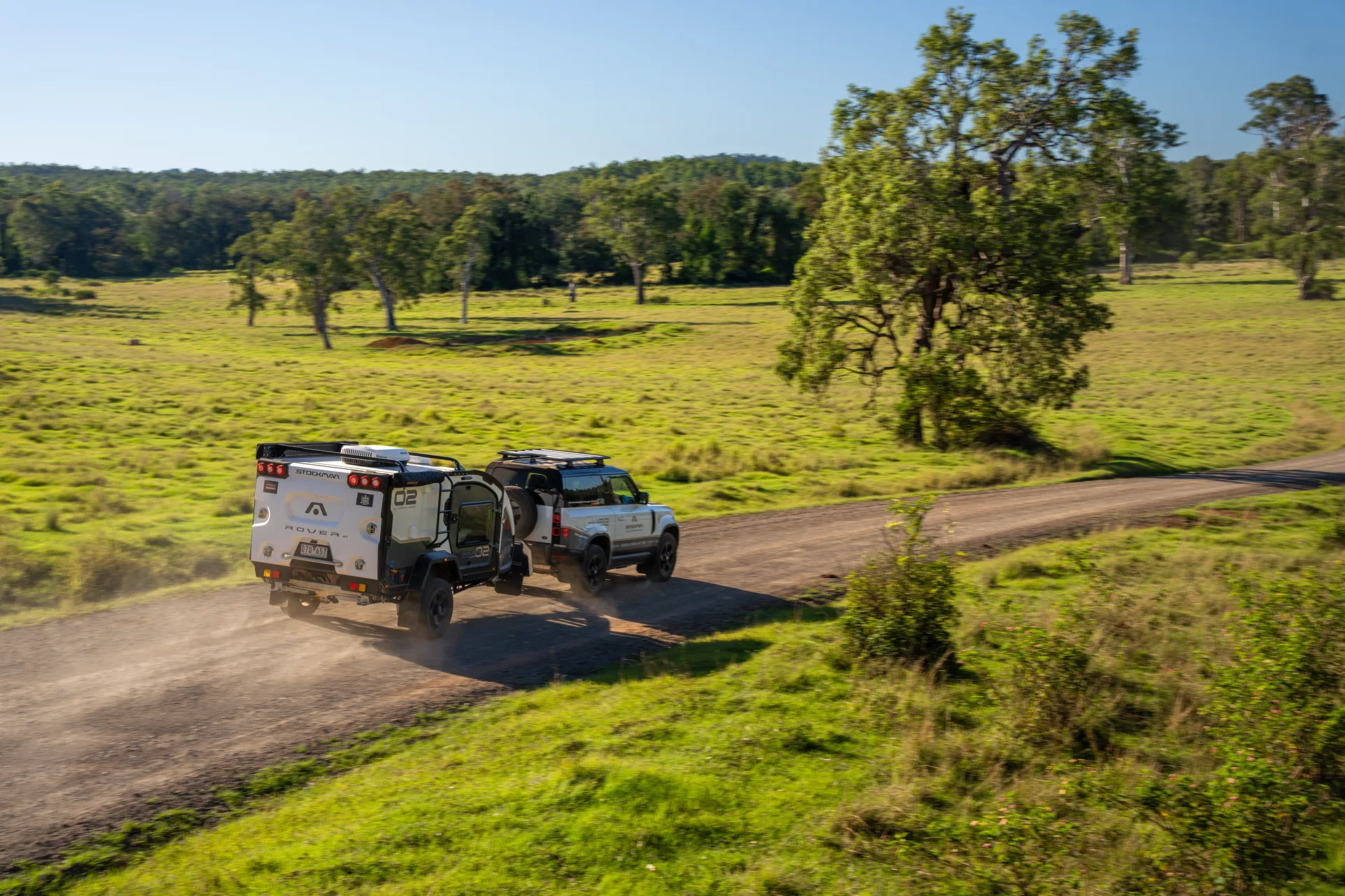 Aerial view of a Stockman Rover 02 towed along a country dam road