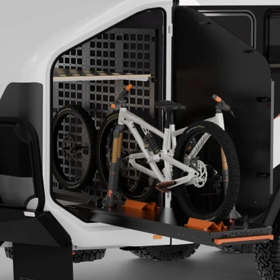 Two e-bikes fork-mounted in the Trekka nosecone with front wheels stored on the MOLLE wall